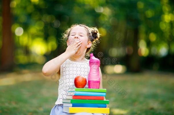 疲倦的值得崇拜的小的小孩女孩阅读书和佃户租种的土地差异