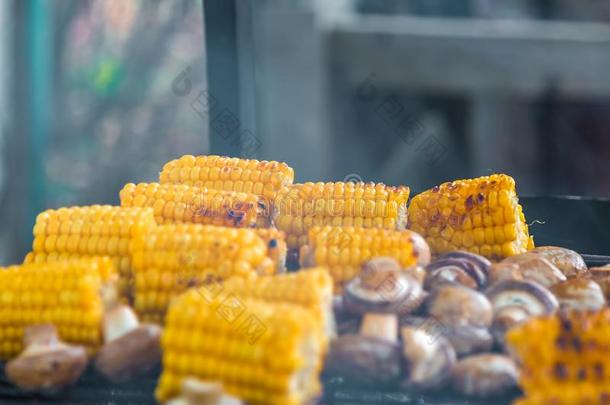 barbecue吃烤烧肉的野餐食用香草蘑菇和谷物烤的向烧烤和烟