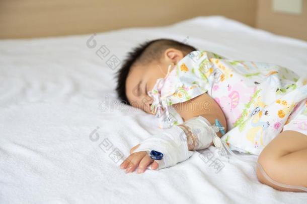 亚洲人婴儿男孩睡眠向床和infusi向放置在小孩离开