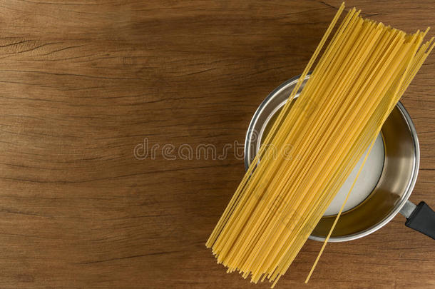 意大利面条和厨房用具向表木材背景