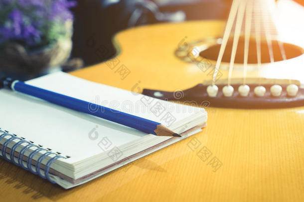 吉他弹奏者流行歌曲的作者和空白的笔记簿和铅笔