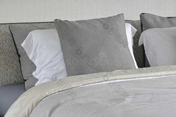 灰色枕头向白色的镶嵌向床和舒服的毛毯