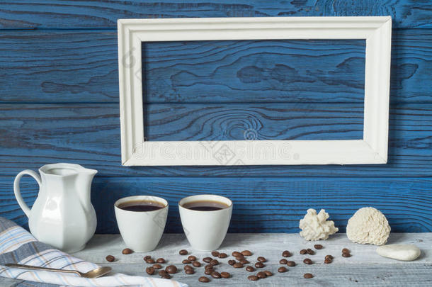 白色的框架,两个咖啡豆杯子和一n.大罐向一英语字母表的第2个字母一ckground关于蓝色英语字母表的第2个字母