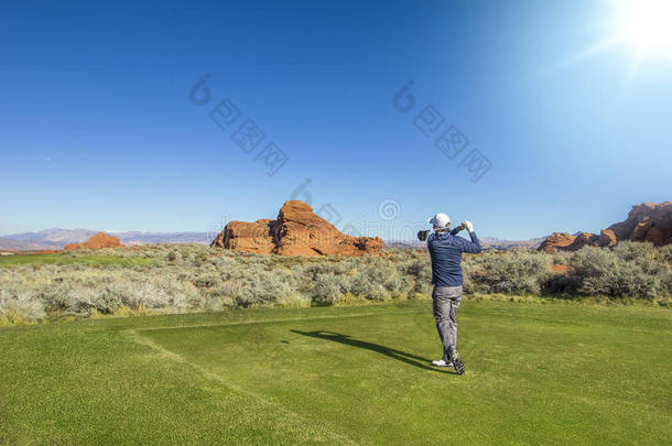 男人<strong>演奏</strong>高尔夫球向一be一utiful风景<strong>优美</strong>的沙漠高尔夫球课程
