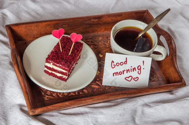 早餐采用床.杯子,咖啡豆,红色的,丝绒,蛋糕和笔记和英语字母表的第20个字母