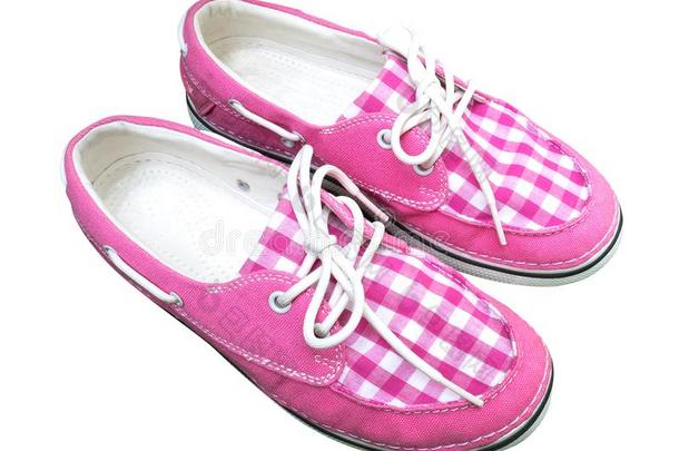 粉红色的彩格呢帆布鞋子隔离的向白色的背景