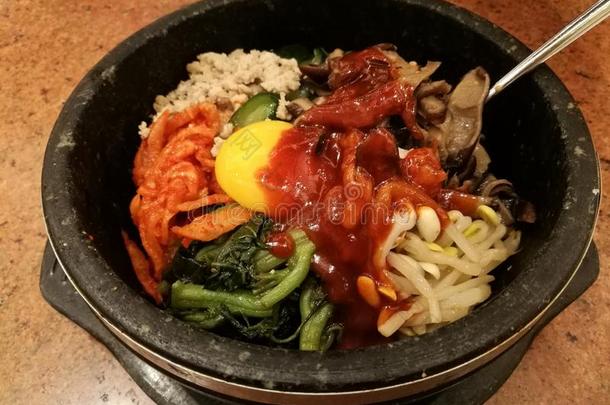 典型的朝鲜食物蔬菜韩式拌饭热的石头罐,稻胡萝卜,
