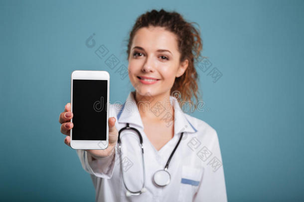 幸福的医生和听诊器展映空白的智能手机屏幕