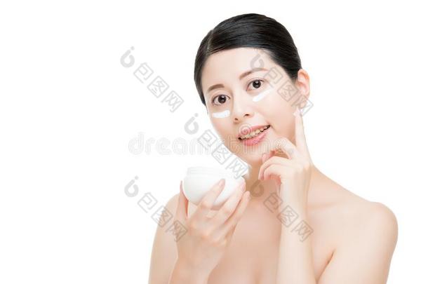 光滑的皮中国人亚洲人女孩使用太阳乳霜.