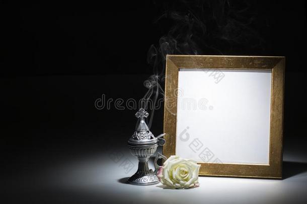 空白的镀金的照片框架和<strong>香炉</strong>和白色的玫瑰
