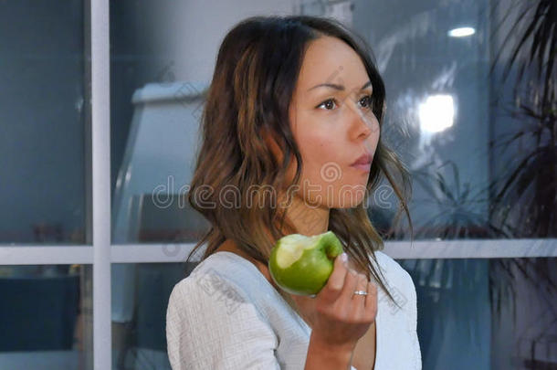 漂亮的女商人吃绿色的<strong>苹果</strong>采用指已提到的人办公室