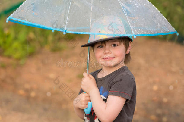 小的男孩在下面雨伞