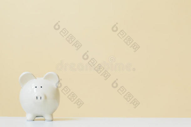 白色的小猪银行向一黄色的b一ckground