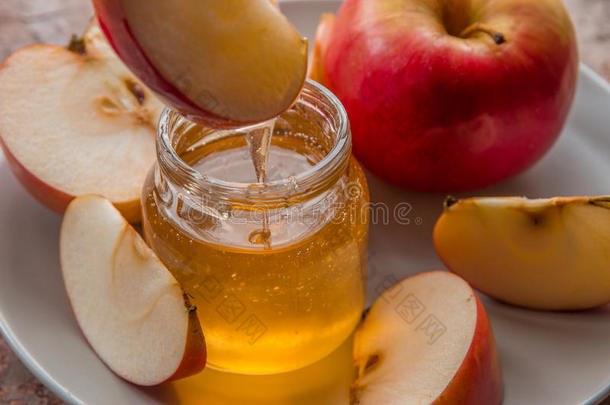有机的<strong>蜂蜜</strong>采用玻璃罐子和红色的<strong>苹果</strong>向指已提到的人盘子