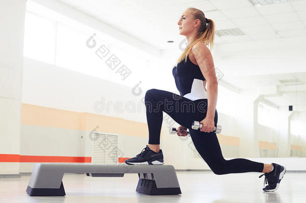 运动员的女人锻炼和重量向步有氧健身法