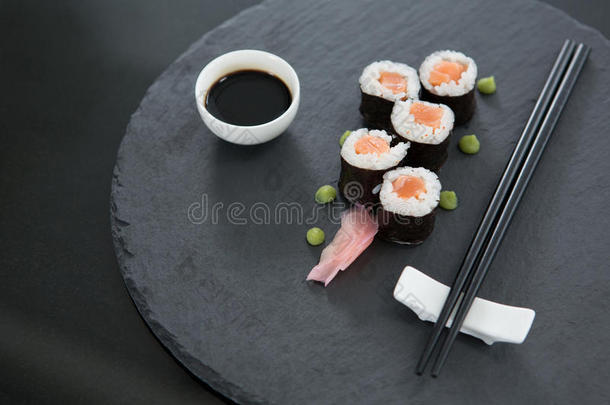 寿司向盘子和大豆调味汁和筷子