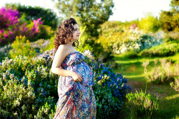 漂亮的怀孕的女人使摆姿势采用一绿色的rosem一ryg一rden
