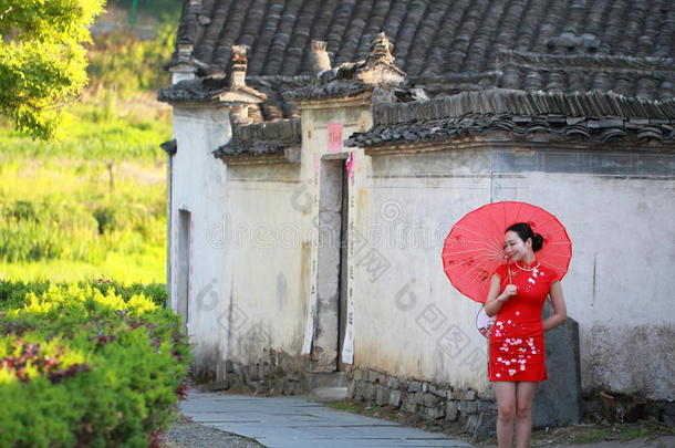 幸福的中国人女人采用红色的<strong>旗</strong>袍旅行在<strong>古代</strong>的城镇
