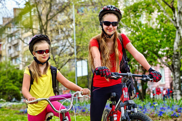 自行车小路和孩子们.女儿使人疲乏的头盔和帆布背包.
