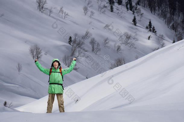 男人和背包起立向下雪的山斜坡.<strong>登山家</strong>或