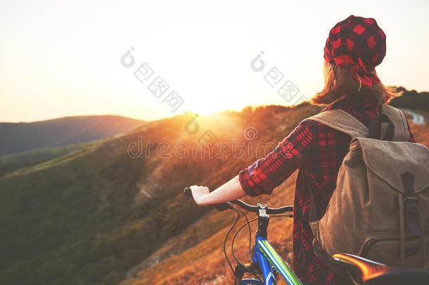 女人旅行者向一自行车一t顶关于mount一in一t日落在户外
