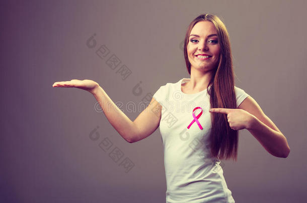 女人粉红色的癌症带向胸部保存敞开的手