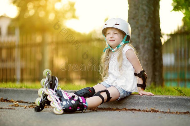 漂亮的小的女孩学问向滚筒溜冰向美丽的夏