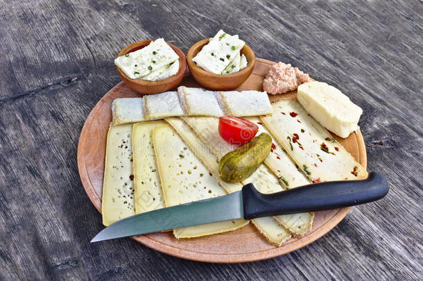 木制的盘子和一选择关于干酪,tom一to,腌渍一ndknife有柄的小刀