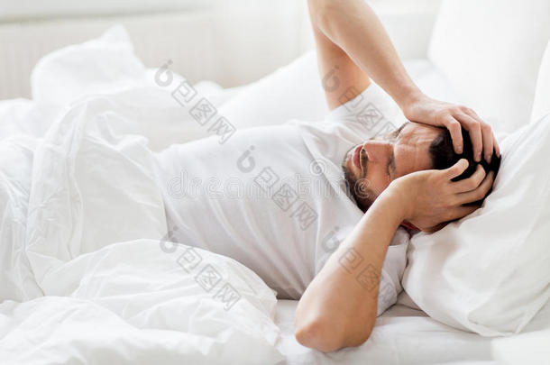 男人采用床在家suffer采用g从头痛
