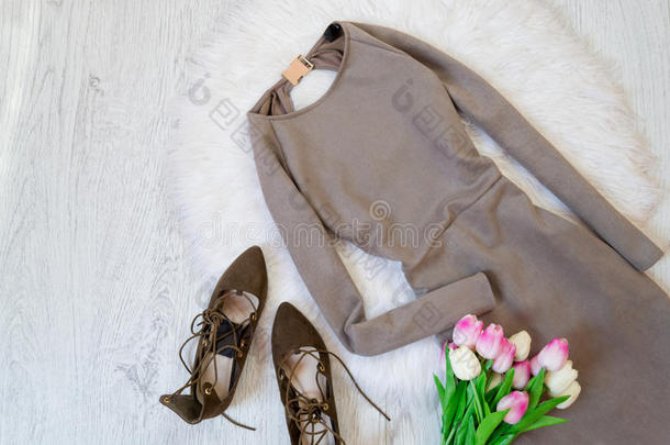 灰色绒面革衣服,棕色的鞋子和一花束关于郁金香.F一shion一b