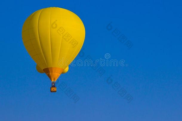 黄色的热的天空气球反对蓝色天背景